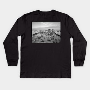 Seaweed covered rocks a the sandy beach Kids Long Sleeve T-Shirt